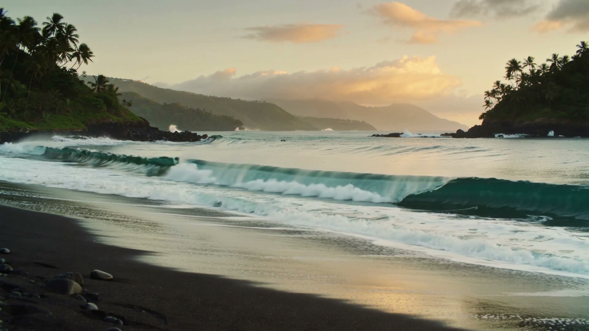 Hawaiian ocean coastline with lush green cliffs and crashing waves at sunrise
